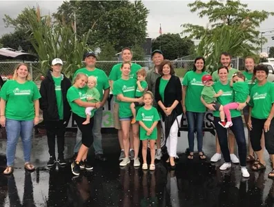 Staff and family in green O'Connell Pharmacy shirts at a community event
